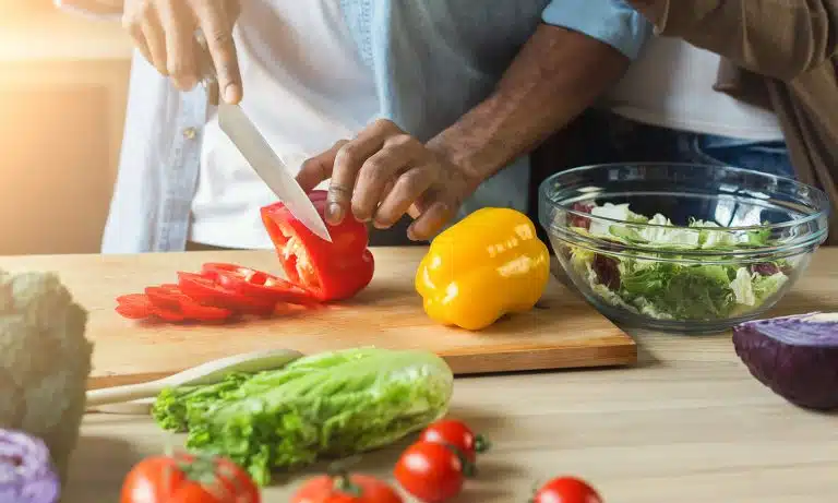 Closeup Man Slicing Veggies Woman Behind 768